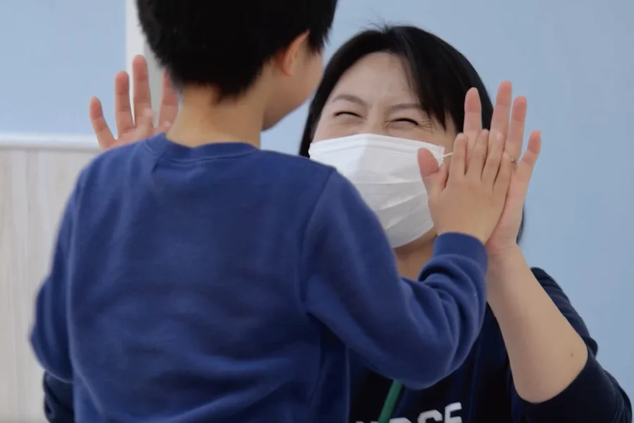 子どもとスタッフのハイタッチ